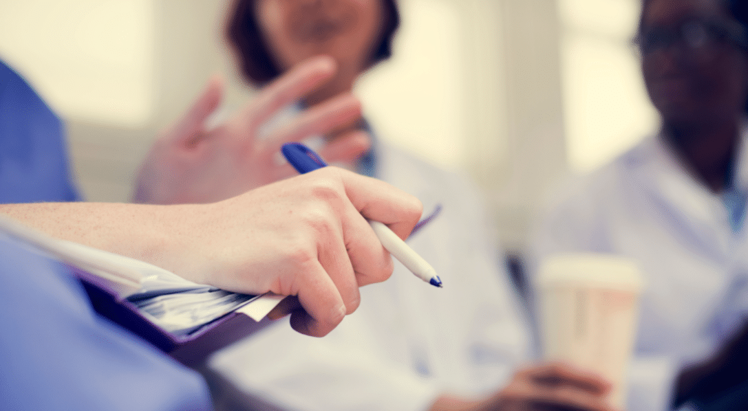 female nurse talking to a group of employees