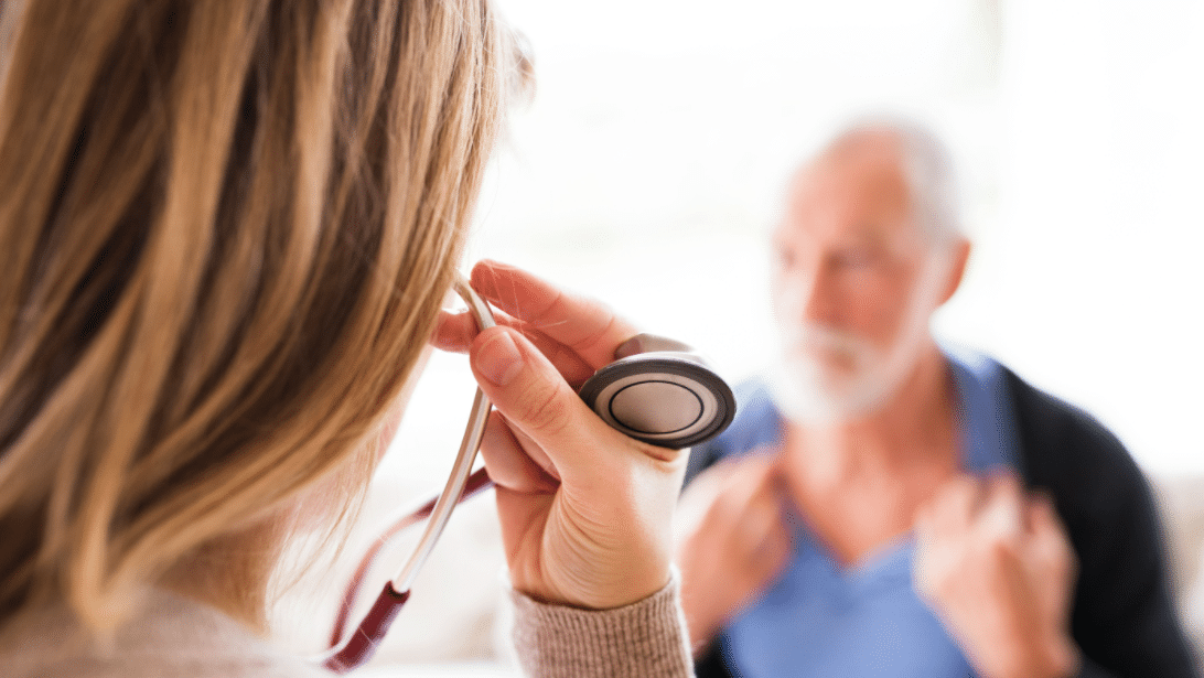 female doctor examining a seated male patient