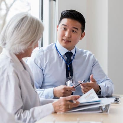 close-up of female doctor discussing documents with a male assistant