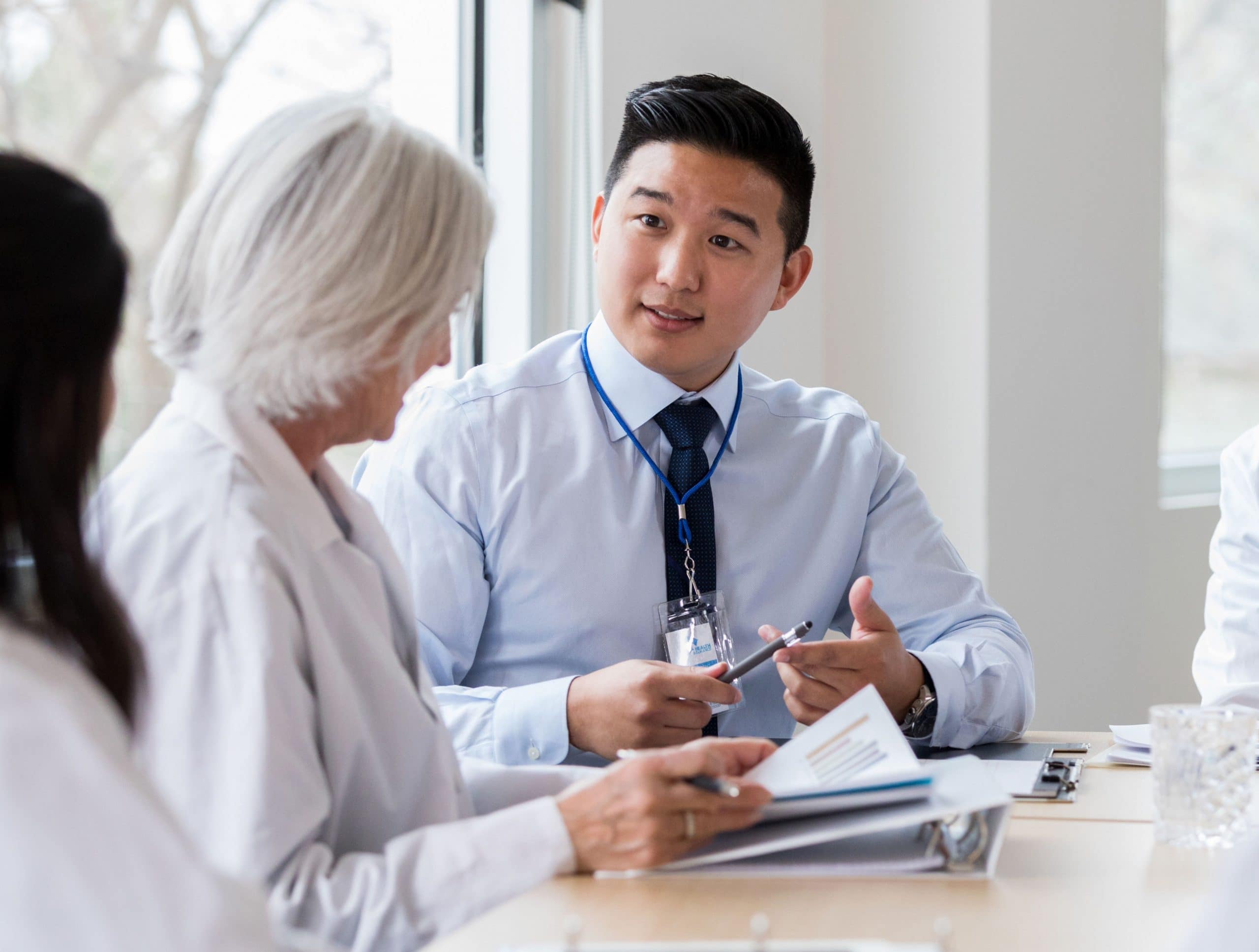 close-up of female doctor discussing documents with a male assistant